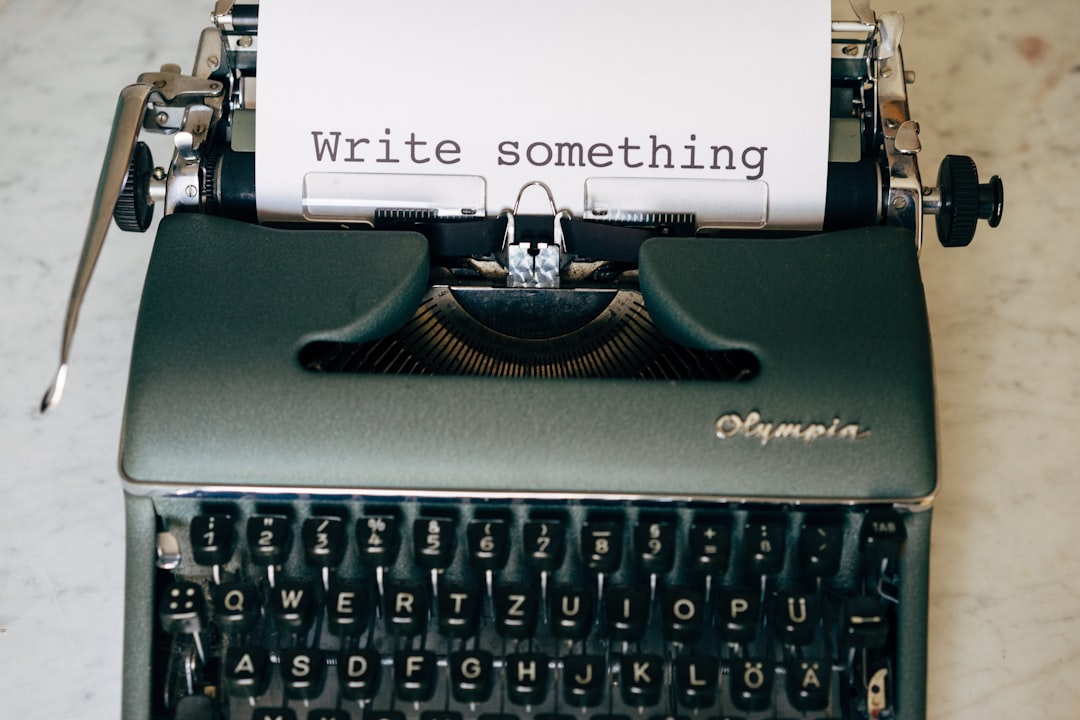 black-and-white-typewriter-on-green-table-nvkjg0alia